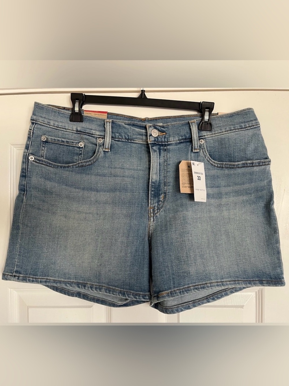 Levi's Women's Mid-Length Denim Shorts with unrolled hem in Medium Indigo Wash